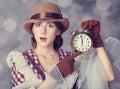 Beautiful redhead women with clock. Royalty Free Stock Photo