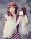 Beautiful redhead women with clock. Royalty Free Stock Photo