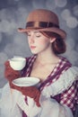 Beautiful redhead women with cup of tea. Royalty Free Stock Photo