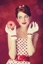 Beautiful redhead women with donut. Royalty Free Stock Photo