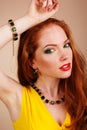 Beautiful redheaded girl with green jewelry