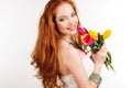 Beautiful redheaded girl is holding tulips Royalty Free Stock Photo