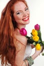 Beautiful redheaded girl is holding tulips Royalty Free Stock Photo