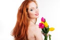 Beautiful redheaded girl is holding tulips Royalty Free Stock Photo