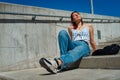 Beautiful redheaded young woman sitting on a staircase outdoors enjoying the sun on her face Royalty Free Stock Photo