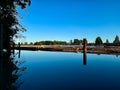 Beautiful reflection of Fraser River on a bright sunny day from Foreshore Park Burnaby