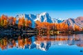 Beautiful reflection of Monte Rosa Italian Alps over Lake Arpy in autumn foliage Italy