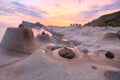 Beautiful reflection of rosy sunrise sky at Yehliu Coast Geologic Park with candlestick rock formations