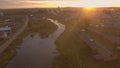 Beautiful reflection of sky in river passing through village. Stock footage. Top view of panorama of Russian town in