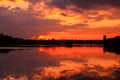 Golden sunset on the water with symmetry of colorful clouds cumulonimbus Royalty Free Stock Photo