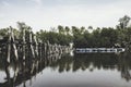 Beautiful reflection on water wooden bridge, coconut tree, mangrove tree and buoy floating