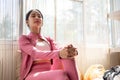 A beautiful and relaxed Asian woman is resting, sitting with her eyes closed on a comfortable couch Royalty Free Stock Photo