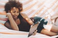 Afro girl on hammock with digital pad Royalty Free Stock Photo