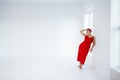 Beautiful relaxed woman in red long dress and red shot hair looking good