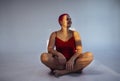 Beautiful relaxed woman in red long dress and red shot hair looking good