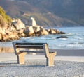 Beautiful relaxing view of the ocean with a bench at the beach on a summer day. The landscape of the sea shore with big Royalty Free Stock Photo