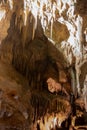 A beautiful Resava cave (Resavska pecina) in Serbia, massive columns of stalagmites and stalactites on the cave bottom.