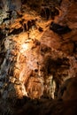 A beautiful Resava cave (Resavska pecina) in Serbia, massive columns of stalagmites and stalactites on the cave bottom.