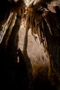 A beautiful Resava cave (Resavska pecina) in Serbia, massive columns of stalagmites and stalactites on the cave bottom.