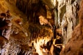 A beautiful Resava cave (Resavska pecina) in Serbia, massive columns of stalagmites and stalactites on the cave bottom.