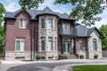 A beautiful residential executive home with brick and stone exterior, and a stone turret.