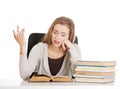 Beautiful resigned student woman with stack of books. Royalty Free Stock Photo