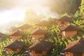 Beautiful resort and vallage is Chinese style with Tea Plantation in mist and sunrise shining on the mountain at Ban Rak Thai, Mae