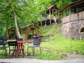 Beautiful restaurant in the mountains. Empty tables of a diner in the woods. Restaurant in nature