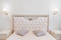 beautiful retro bedroom interior with a large classic bed with a soft headboard. Royalty Free Stock Photo