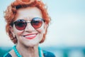 Beautiful retro older woman in front of the brick wall