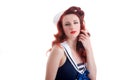 Beautiful retro pin-up girl in a sailor style dress Royalty Free Stock Photo