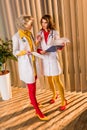 beautiful retro styled doctors with clipboards talking