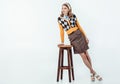 beautiful retro styled girl leaning on wooden chair Royalty Free Stock Photo