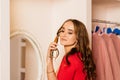 Beautiful retro young woman vintage secretary in red dress talking telephone