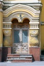 Beautiful richly decorated entrance of yellow stone historical 19th century building in russian architectural style in Moscow