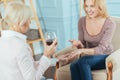 Positive woman boasting her engagement ring and smiling cheerfully