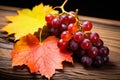 Beautiful Ripe Grape And Autumn Leaves On Wooden Table