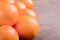 Beautiful ripe oranges on brown table