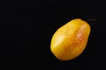 Beautiful ripe yellow pear on black background Royalty Free Stock Photo