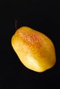 Beautiful ripe yellow pear on black background Royalty Free Stock Photo