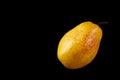 Beautiful ripe yellow pear on black background Royalty Free Stock Photo
