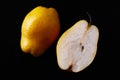 Beautiful ripe yellow pear cut in a half on black background Royalty Free Stock Photo