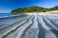 Beautiful ripple marks in black and white sand beach at sunshine Royalty Free Stock Photo