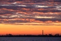 Beautiful rising sun and clouds with chimney of a factory in the Netherlands