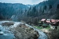 Beautiful river with houses on bank in mountains Royalty Free Stock Photo