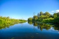 A beautiful river landscape, trees reflecting in the water surface.