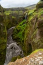 Beautiful river with tiny waterfall in Iceland surrounded by green cliff Royalty Free Stock Photo