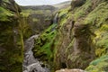 Beautiful river with tiny waterfall in Iceland surrounded by green cliff Royalty Free Stock Photo