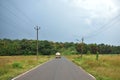 Beautiful road in Autumn season with green fields and cloudy sky in Goa Royalty Free Stock Photo