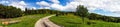 Beautiful road in green fields, natural landscape Royalty Free Stock Photo